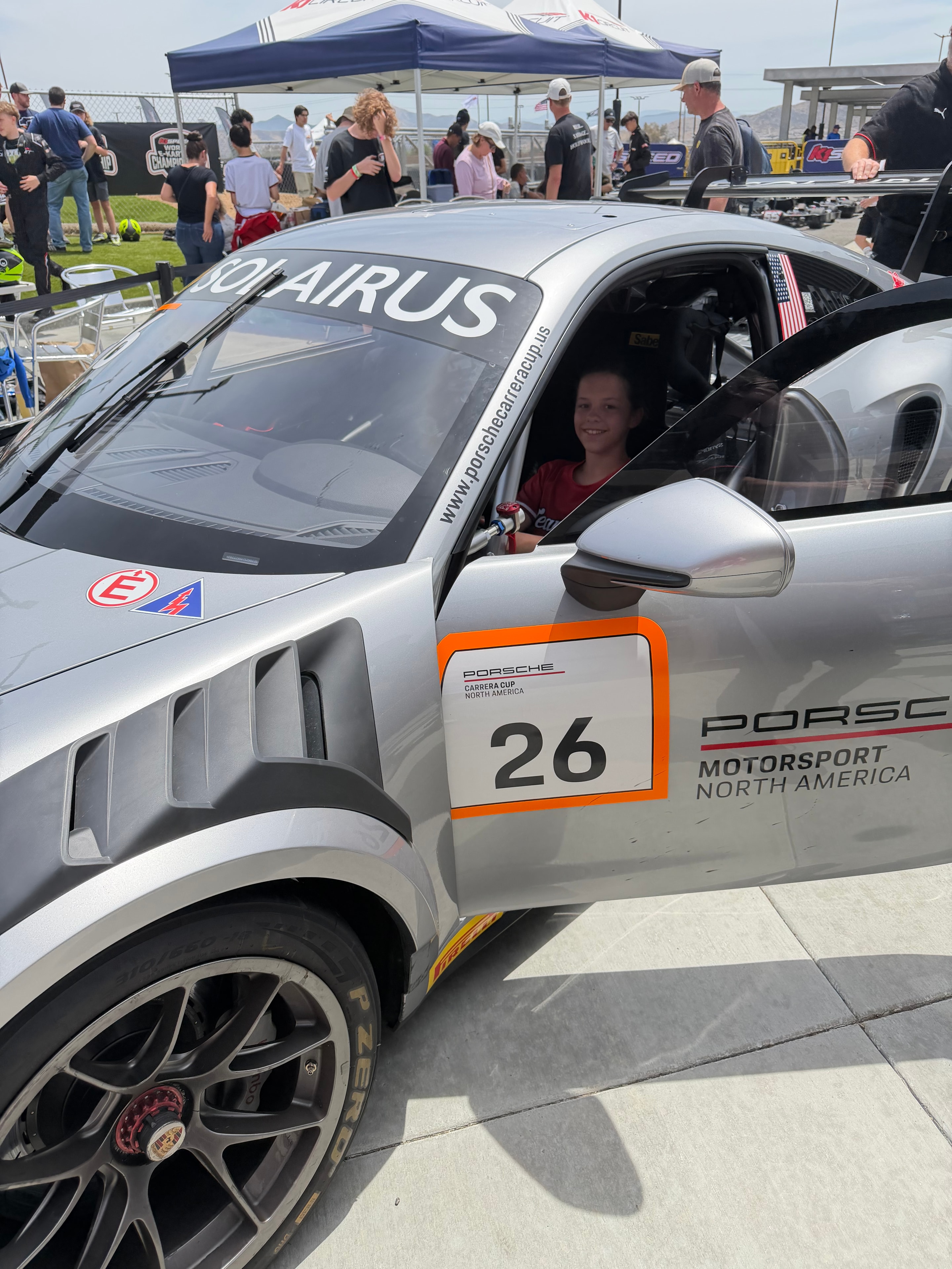 Autumn sitting in a Porsche Cup race car #26