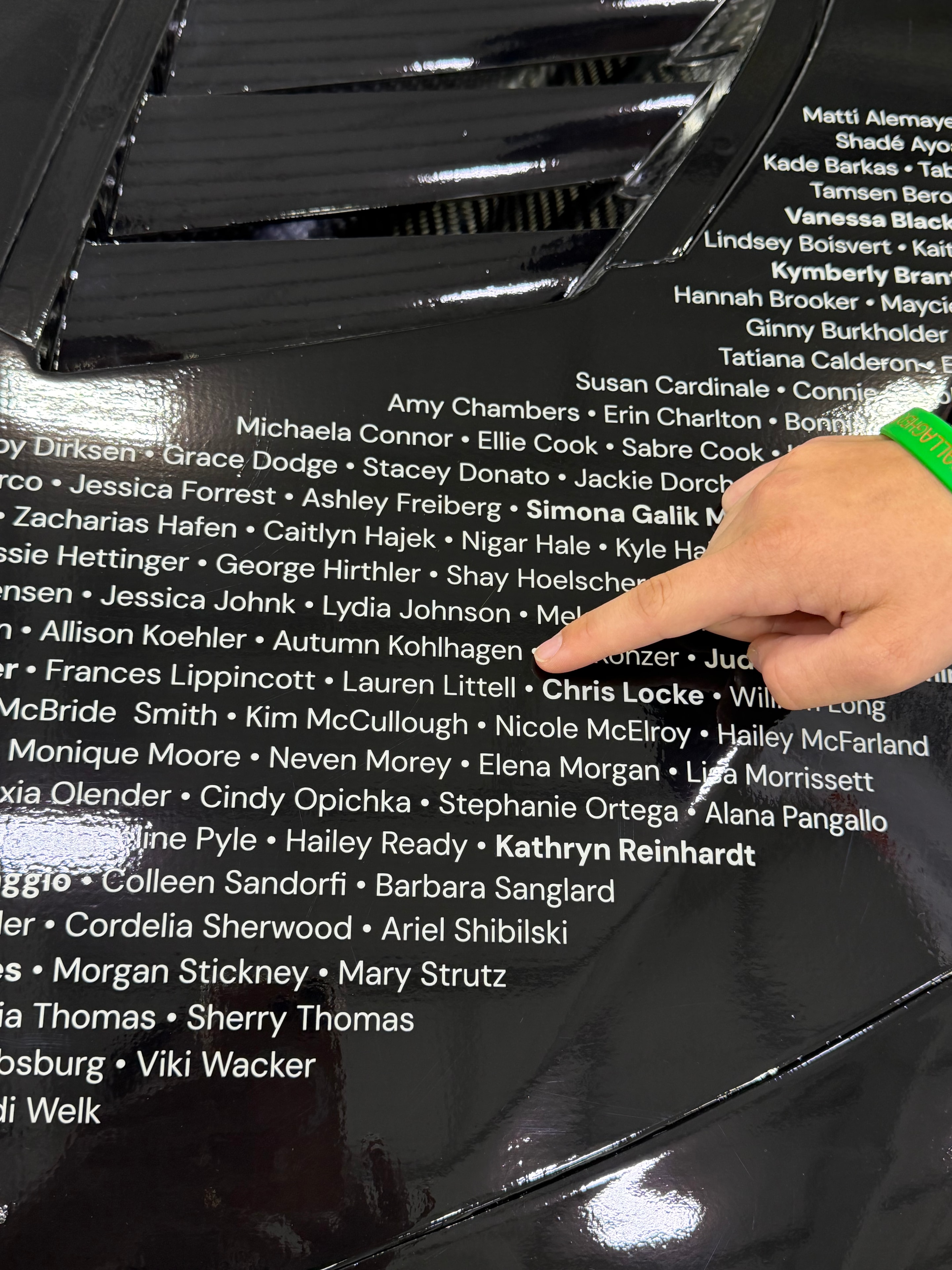 Autumn points to her name on Daniel Suárez's No. 7 WIMNA Nation NASCAR at Spire Motorsports